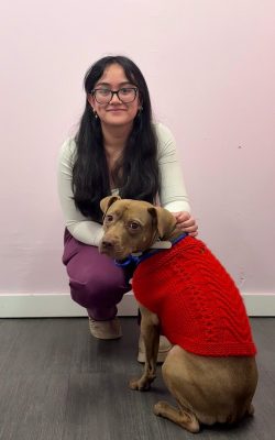 shelby with a brown dog wearing a red coat