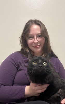 Willow holding a black cat
